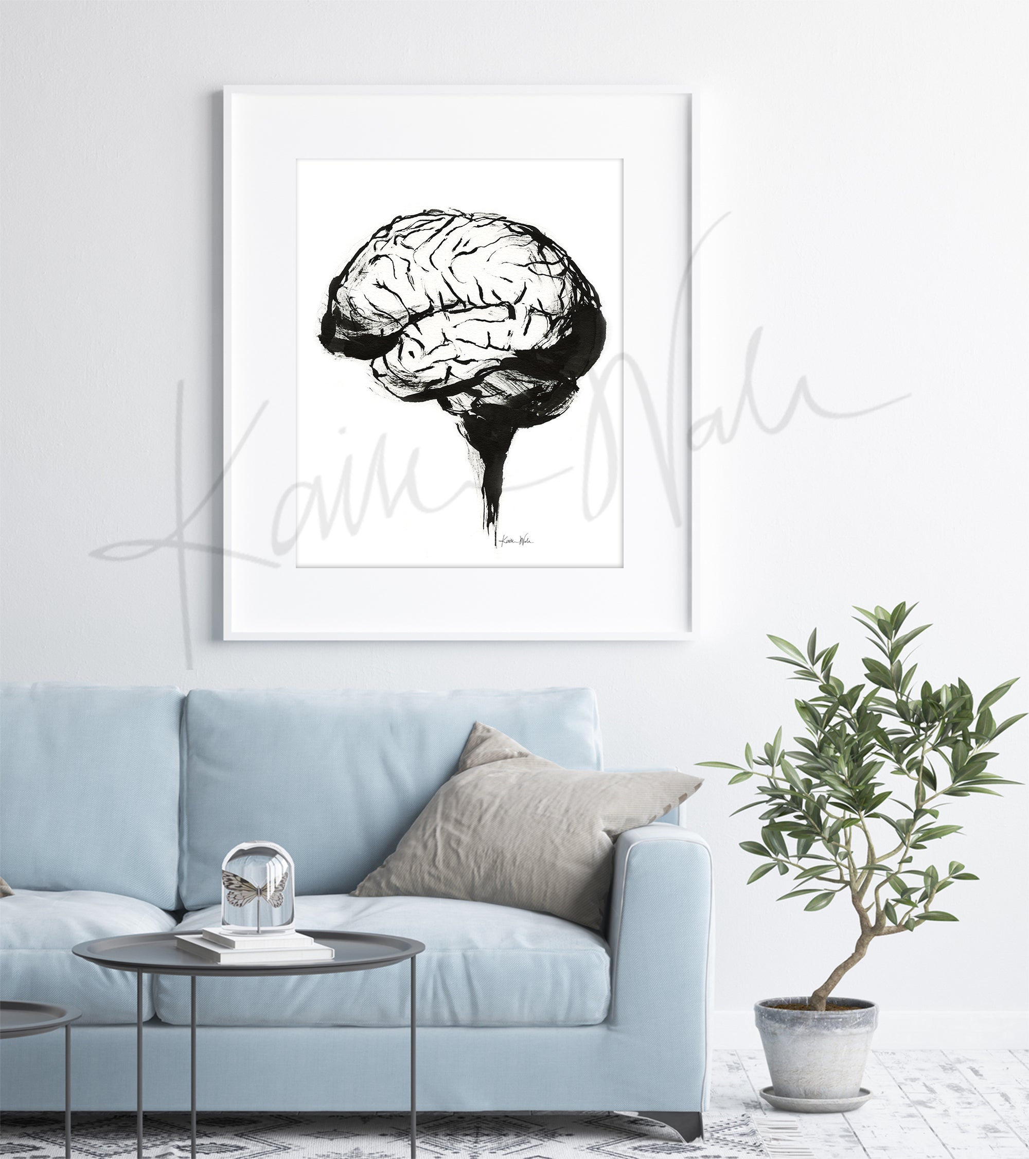 Framed artwork of a brain on a wall above a light blue sofa in a clinic.