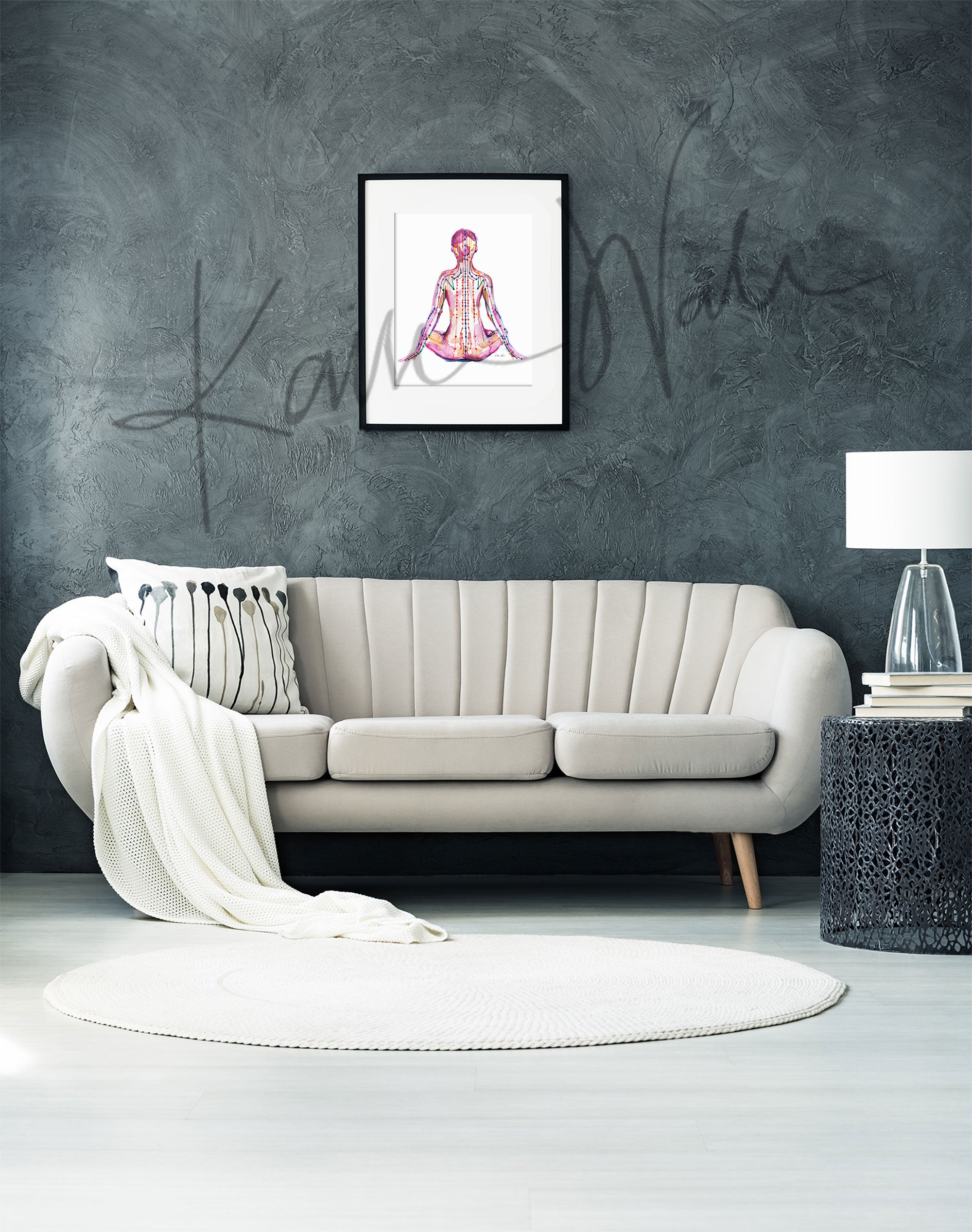 Framed watercolor painting of a person sitting in a meditative pose with meridian paths showing. The painting is hanging over a white couch.