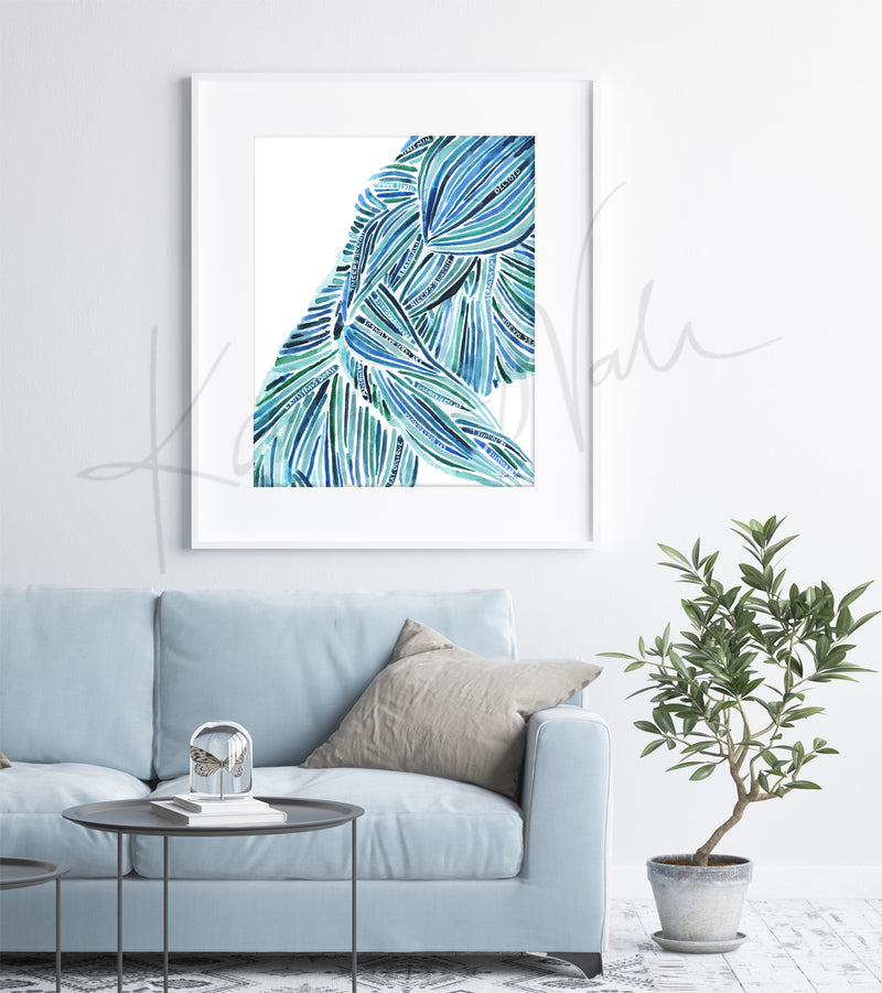 Framed watercolor painting of an abstract body with labeled muscles. The painting is hanging over a blue couch.