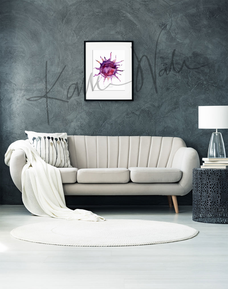 Framed watercolor painting of a platelet. The painting is hanging over a white couch.