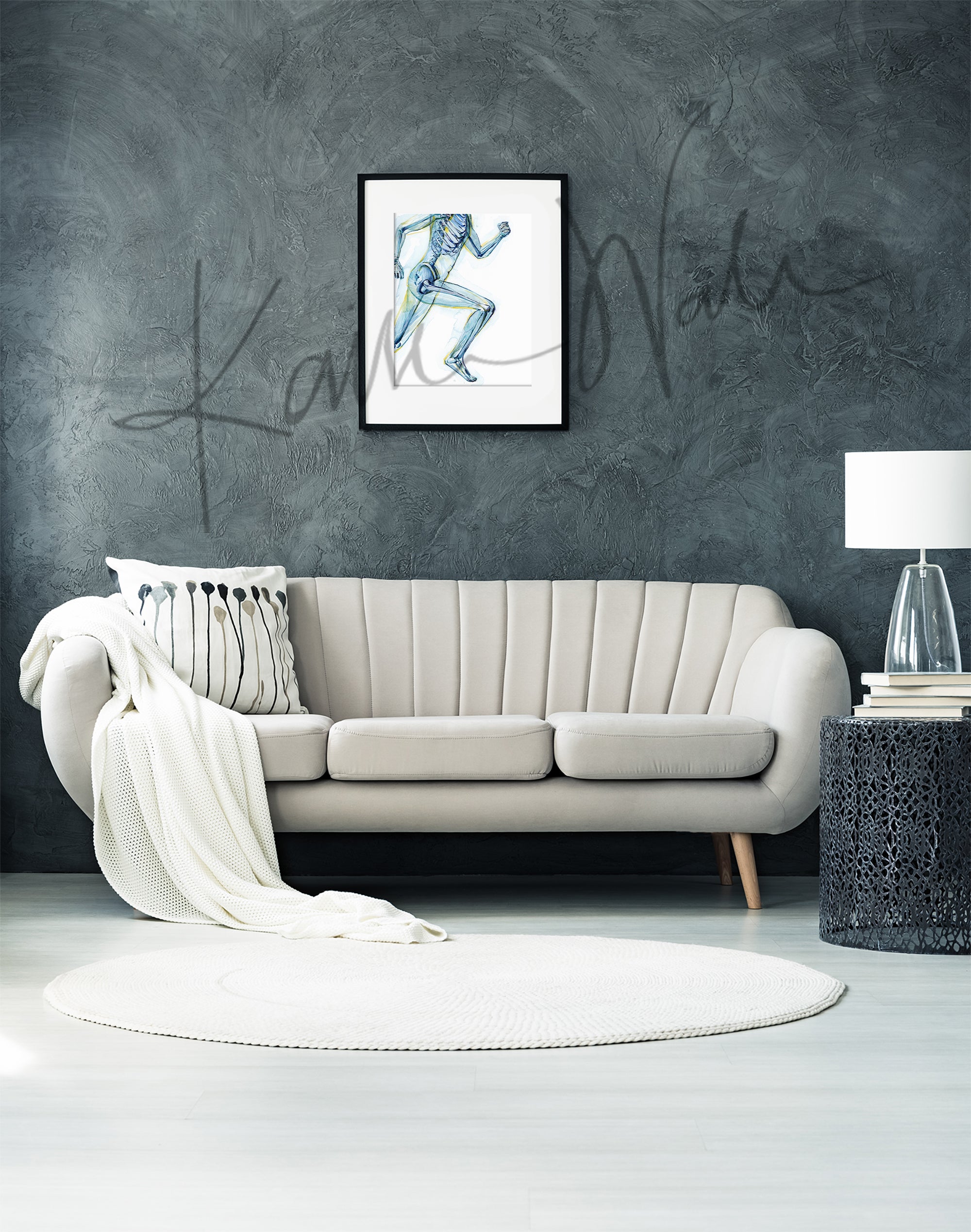 Framed watercolor painting of a runner, showing the skeletal structure beneath. The painting is hanging over a beige couch.
