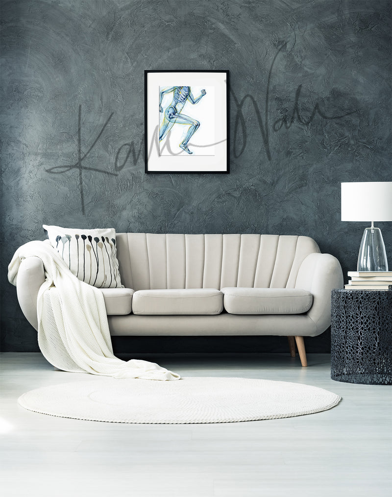 Framed watercolor painting of a runner, showing the skeletal structure beneath. The painting is hanging over a beige couch.